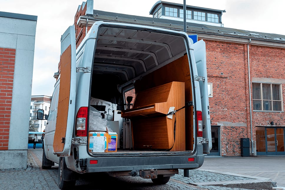 Upright piano loaded and secured inside an Oakley Relocation moving van