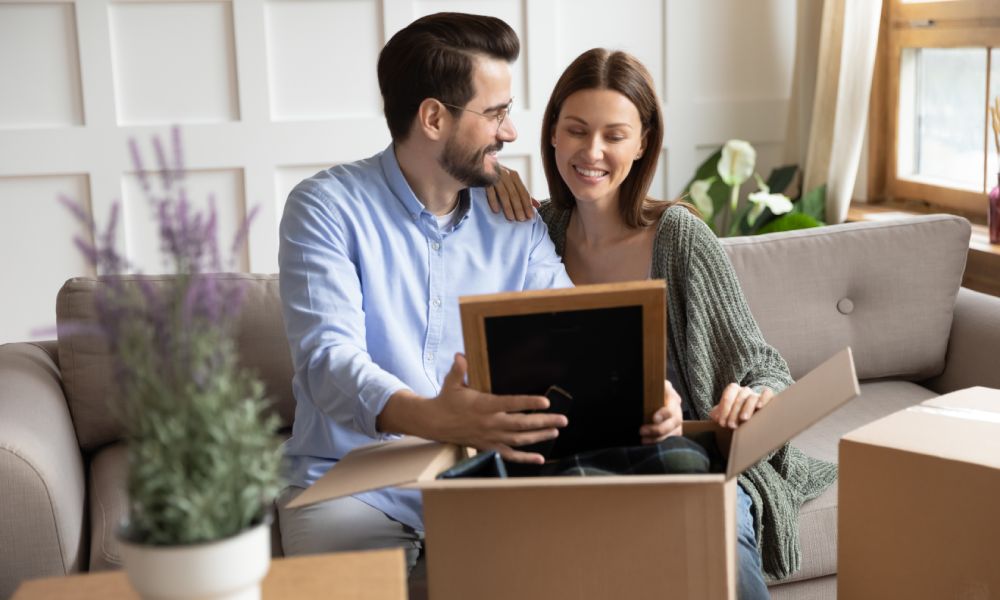 Happy wife and husband looking at photo frame