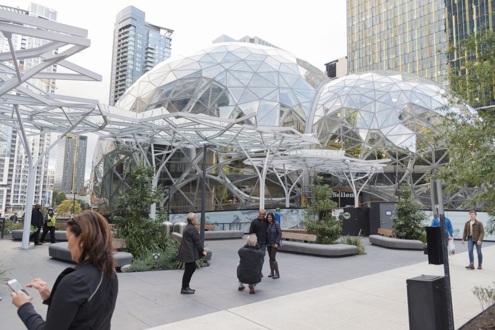 the Amazon world headquarters campus and office towers featuring the Spheres terrariums with people located in downtown Seattle taken late afternoon under overcast sky circa March 2020.