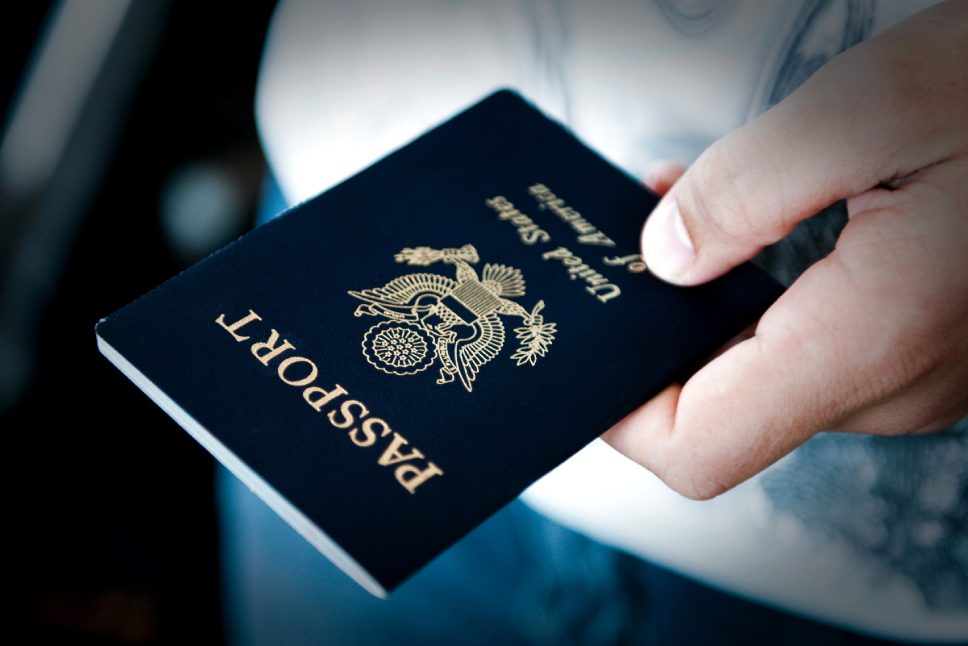 Image of a persons hand holding a passport