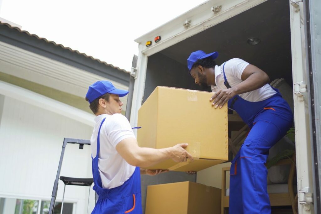 Team of employee workers with a truck car moving house for customers, delivering boxes with uniform.Vehicle transportation. Shipping and packaging business occupation service company. People lifestyle