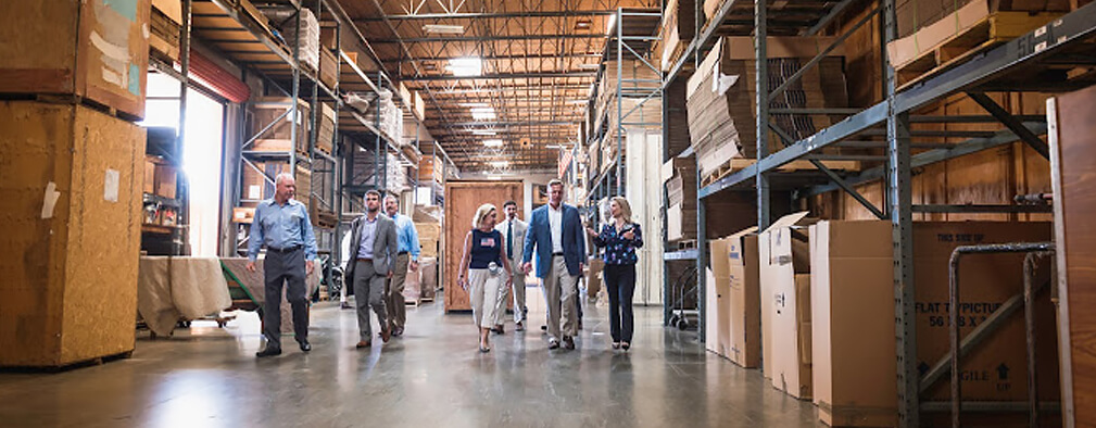 corporate employees in a warehouse