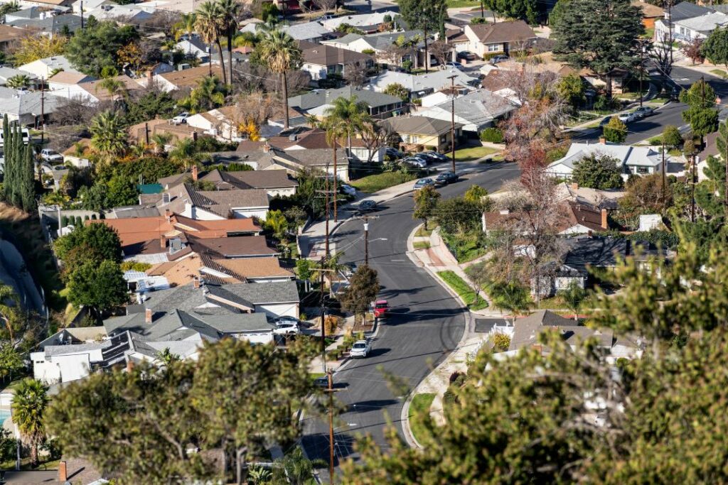 Hilltop view of houses and curvy suburban streets in the northeast San Fernando Valley area of Los Angeles, California.