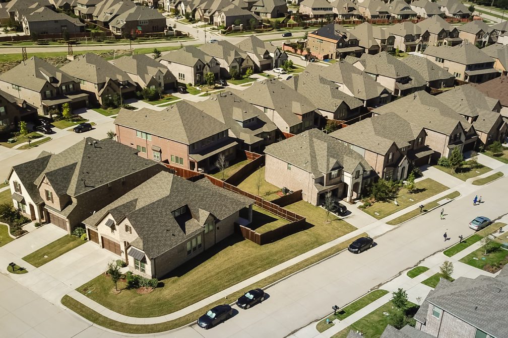 Panorama aerial view new development community with row of detached single-family house and garden. Flyover residential area suburban Dallas, Texas, USA