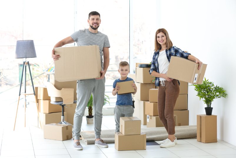 Happy family with cardboard boxes. Moving concept