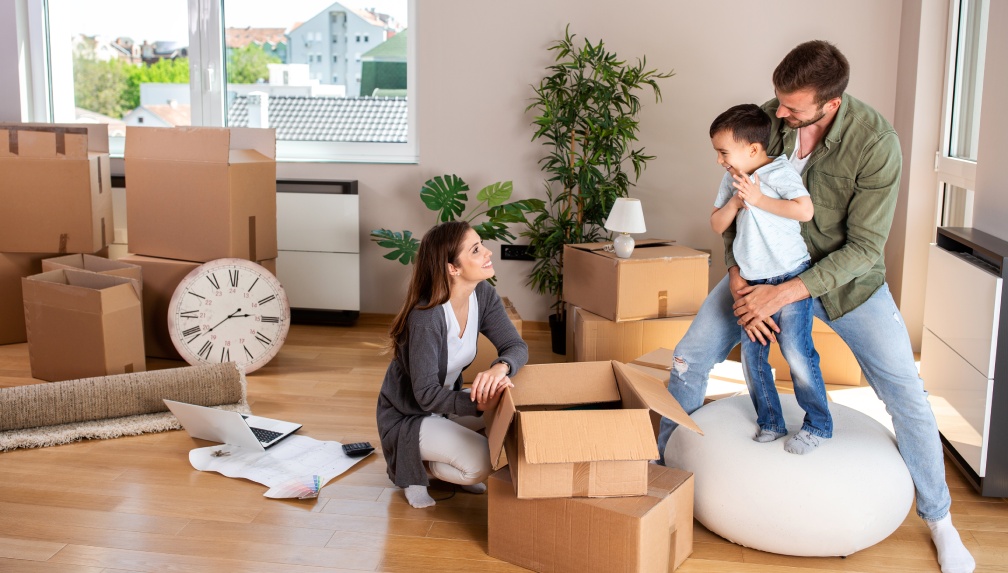 Happy family moving in and having fun while doing so
