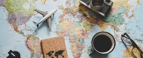 international moving, coffee, camera, and other articles over a map.