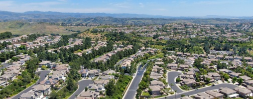 Aerial view of Lake Mission Viejo, with recreational facilities, surrounded by private residential and condominium communities. Orange County, California, USA