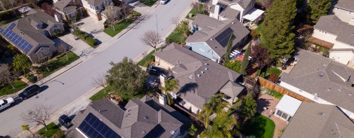 A neighborhood with a solar panel on the roof