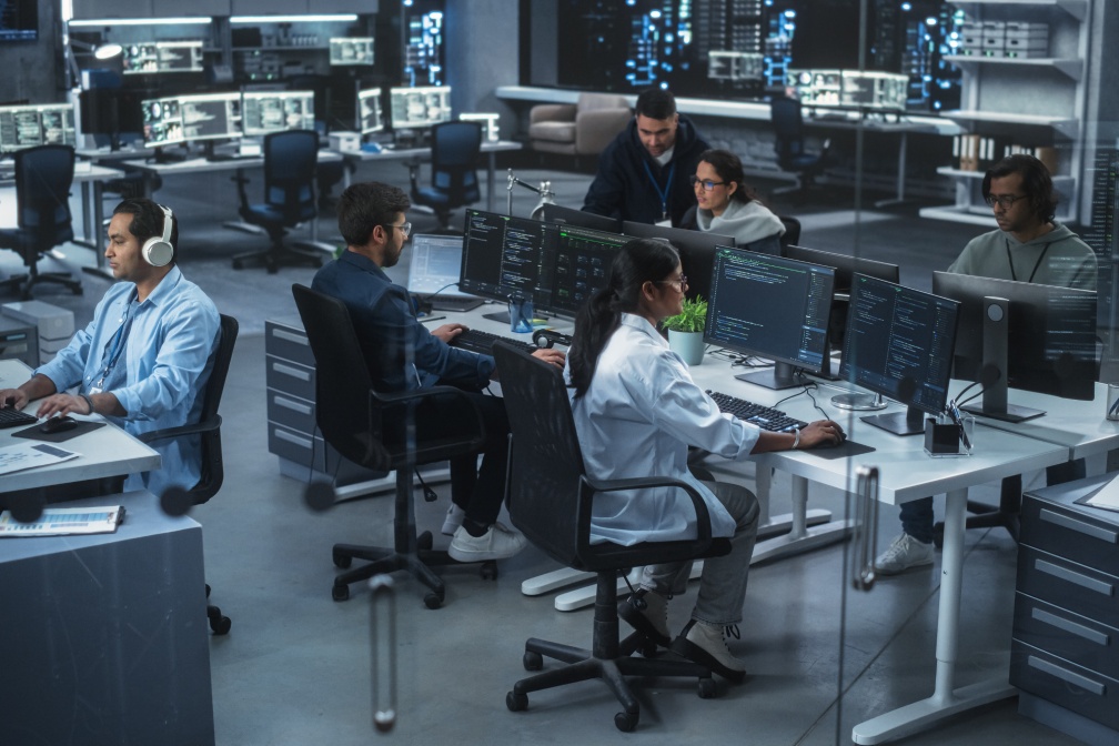 Diverse Young Indian Colleagues Working on Computers in a Research Laboratory. Focus on Female Software Developer Colleague Working on a Solution for Their Collaborative Industrial Tech Project