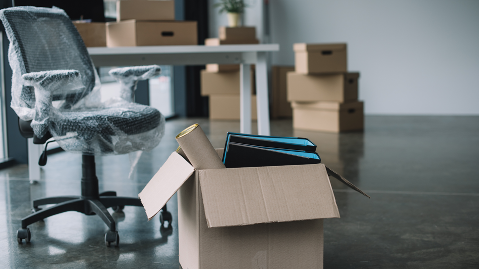 Moving crew members in blue uniforms pushing a washing machine