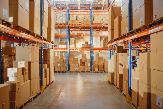 Retail Warehouse full of Shelves with Goods in Cardboard Boxes and Packages. Logistics, Sorting and Distribution Facility for Product Delivery.