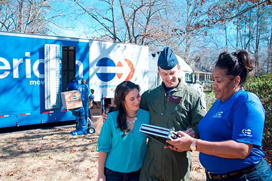 moving company with woman and young man veteran coming back