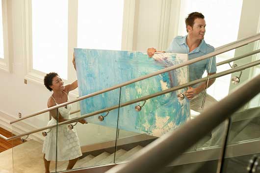 couple moving big painting