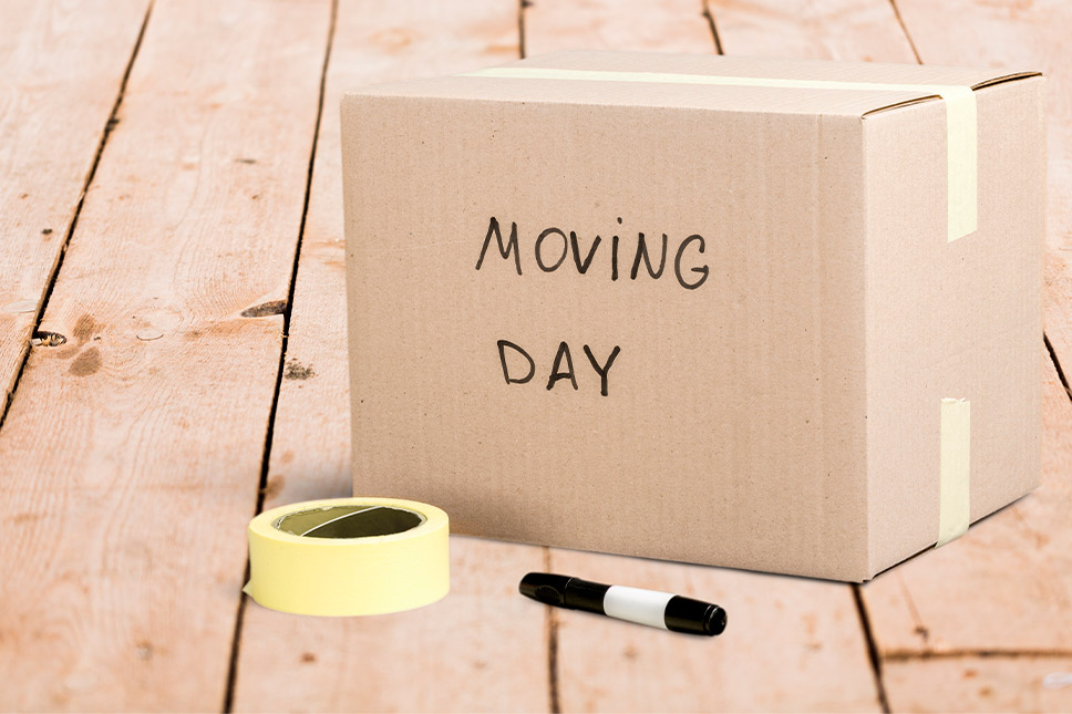 Tools to help with a move:moving box with tape and sharpie.