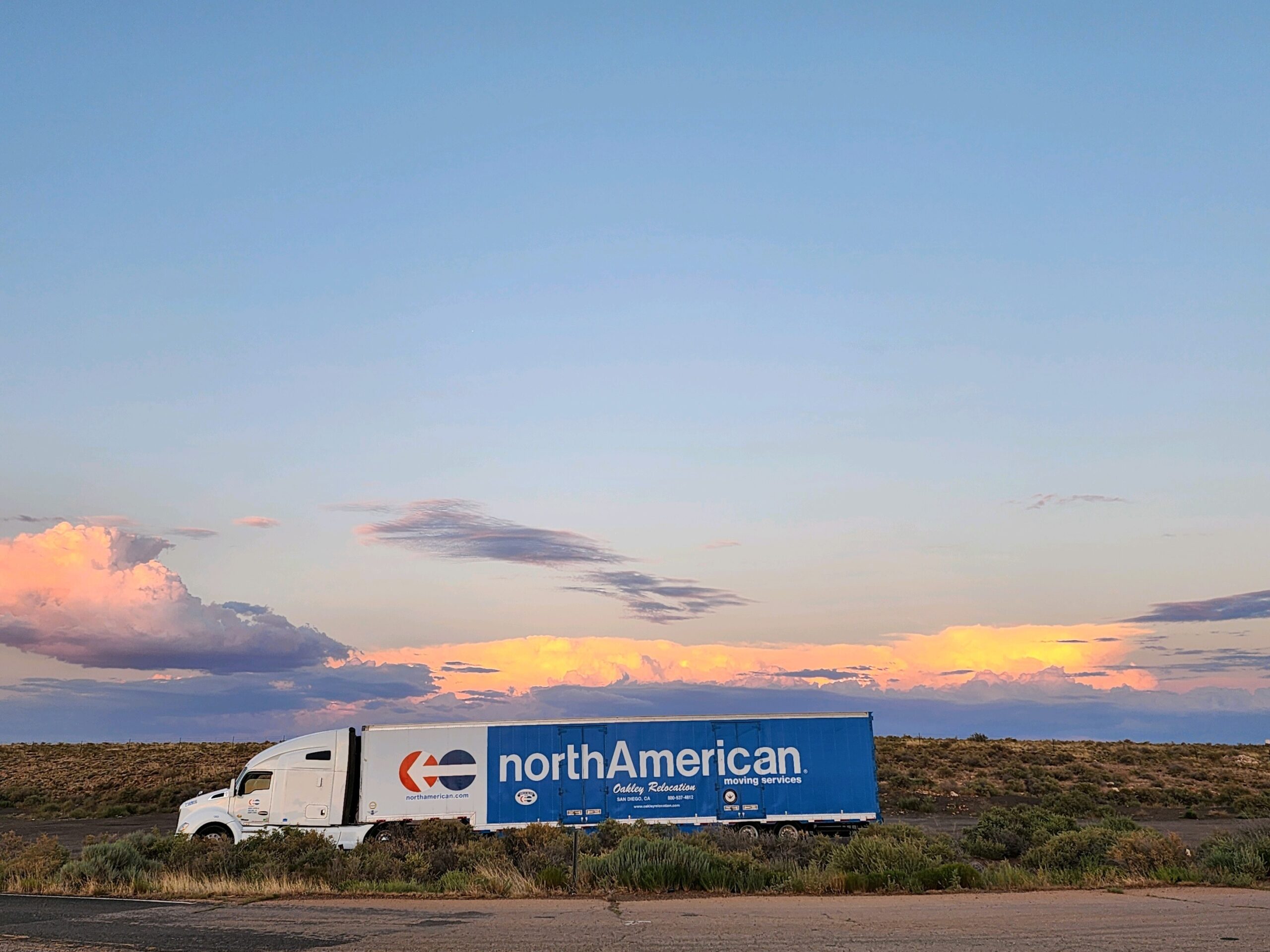 moving Truck by Oakley Relocation on USA road. Sunset behind