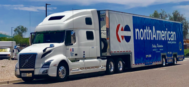 moving Truck by Oakley Relocation on USA road. Sunset behind
