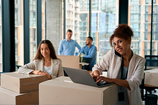 A vibrant street adorned with palm trees and a clock tower, illustrating the Inland Empire guide for corporate office relocation.