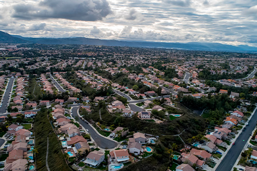 Overhead view of a San Diego residential area, highlighting houses and greenery in the cityscape of California.
