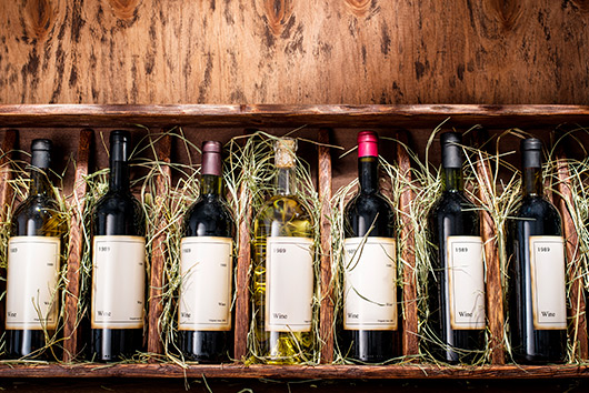 A selection of wine bottles neatly arranged in a wooden box, part of a wine collection relocation in Southern California.