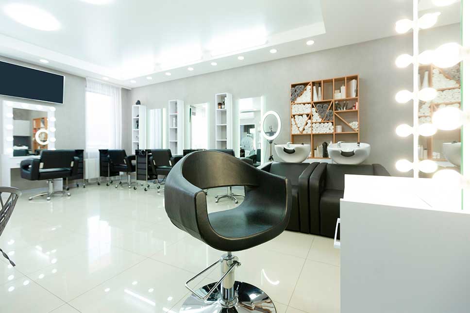 Interior view of a salon showcasing multiple styling chairs and mirrors for hairdressing services.. Moving guide