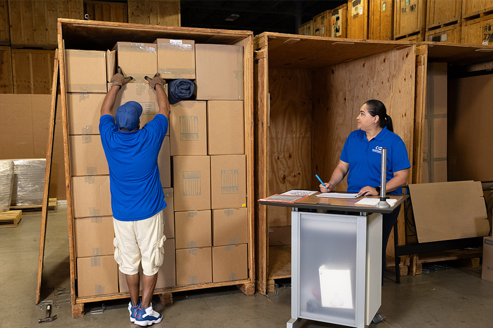 Two individuals managing boxes in a warehouse, highlighting long-term storage options in San Marcos.