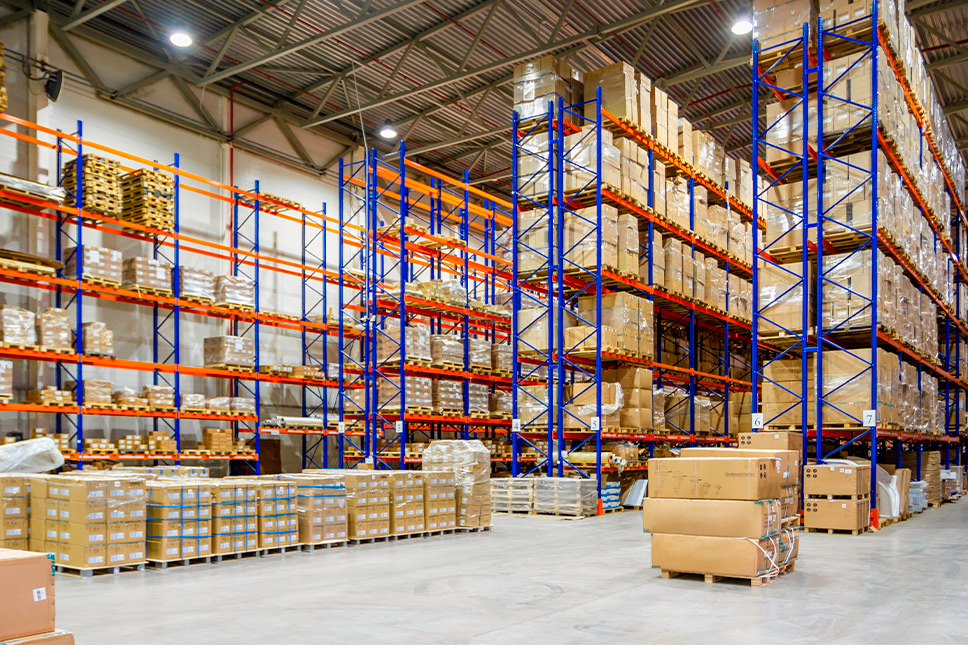 Interior of a spacious warehouse showcasing numerous shelves stacked with boxes, part of the Winter Storage Guide for San Marcos.