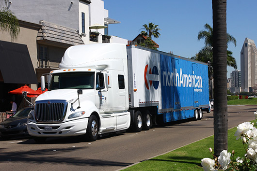 A white truck driving on the road, featured in the San Diego guide for government office moving.